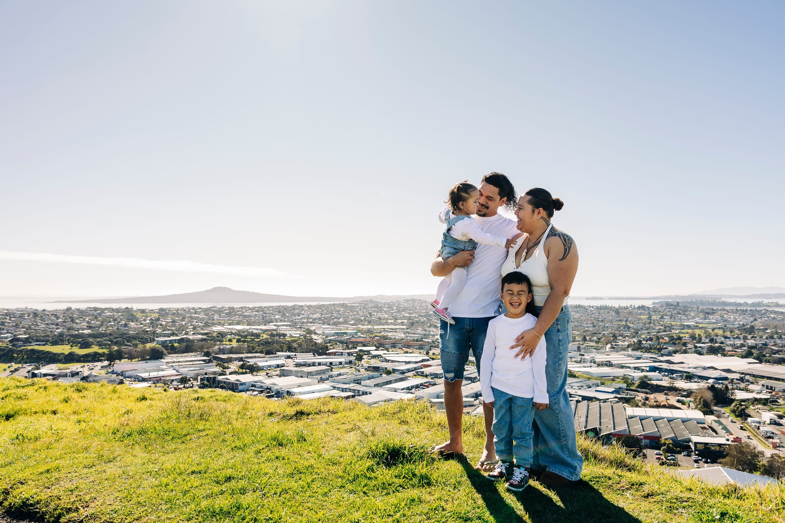 Whānau on a hillside overlooking Auckland