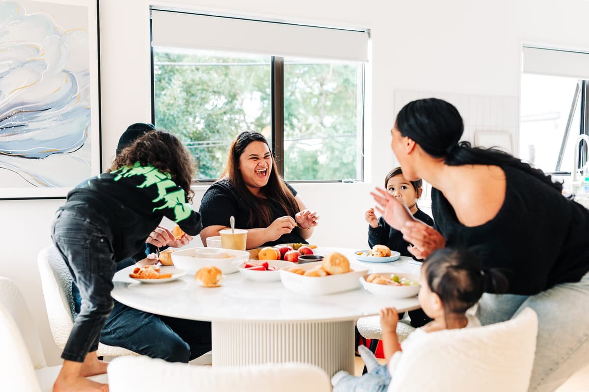 Whānau together around a table